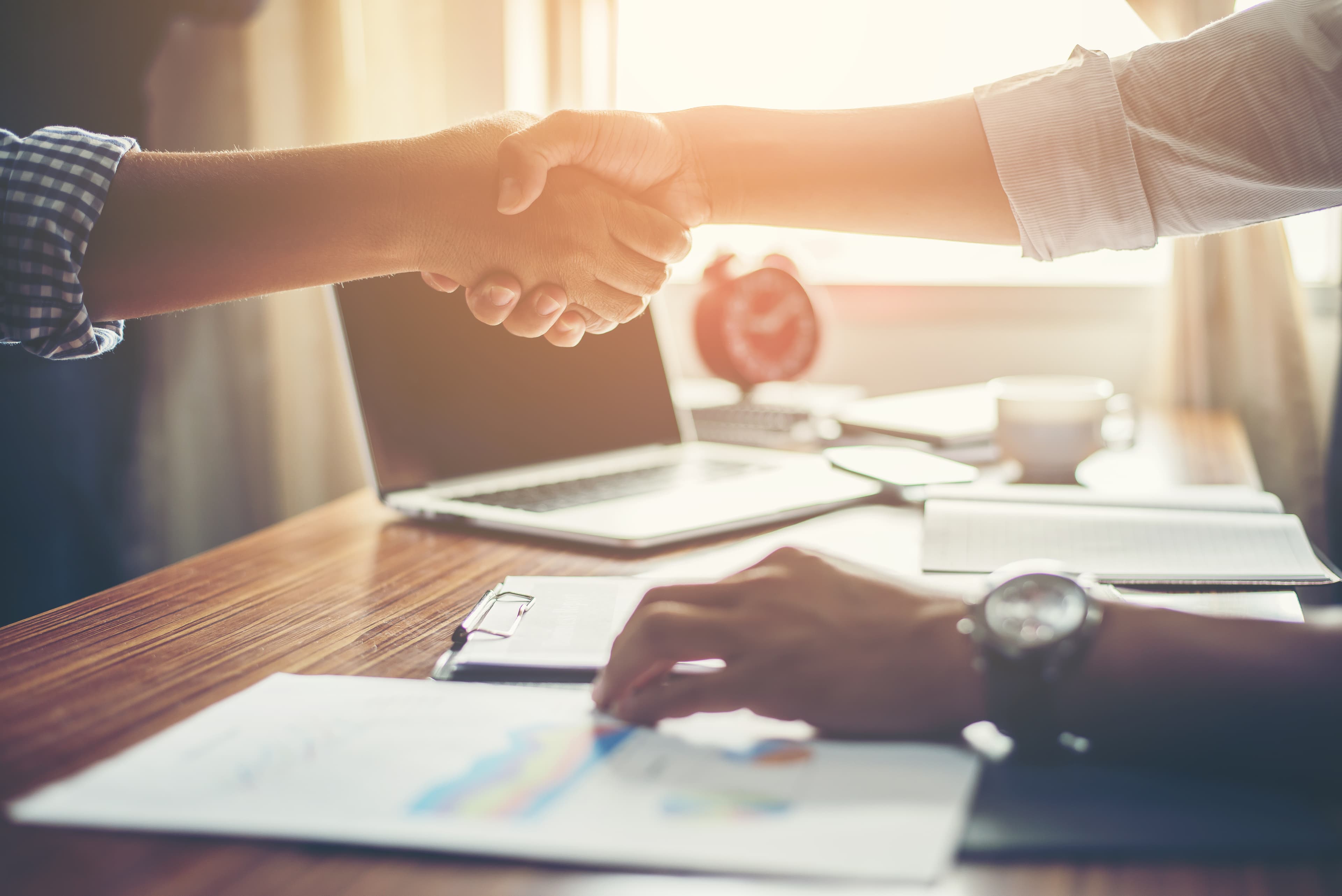 Business owners shaking hands after reaching a financing agreement